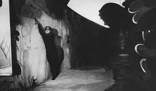 The diagonal composition associated with the wall dictates the activity of the star, along with his tight black colored clothes leading to the compositional impact. (Dr. Caligari, 1920)